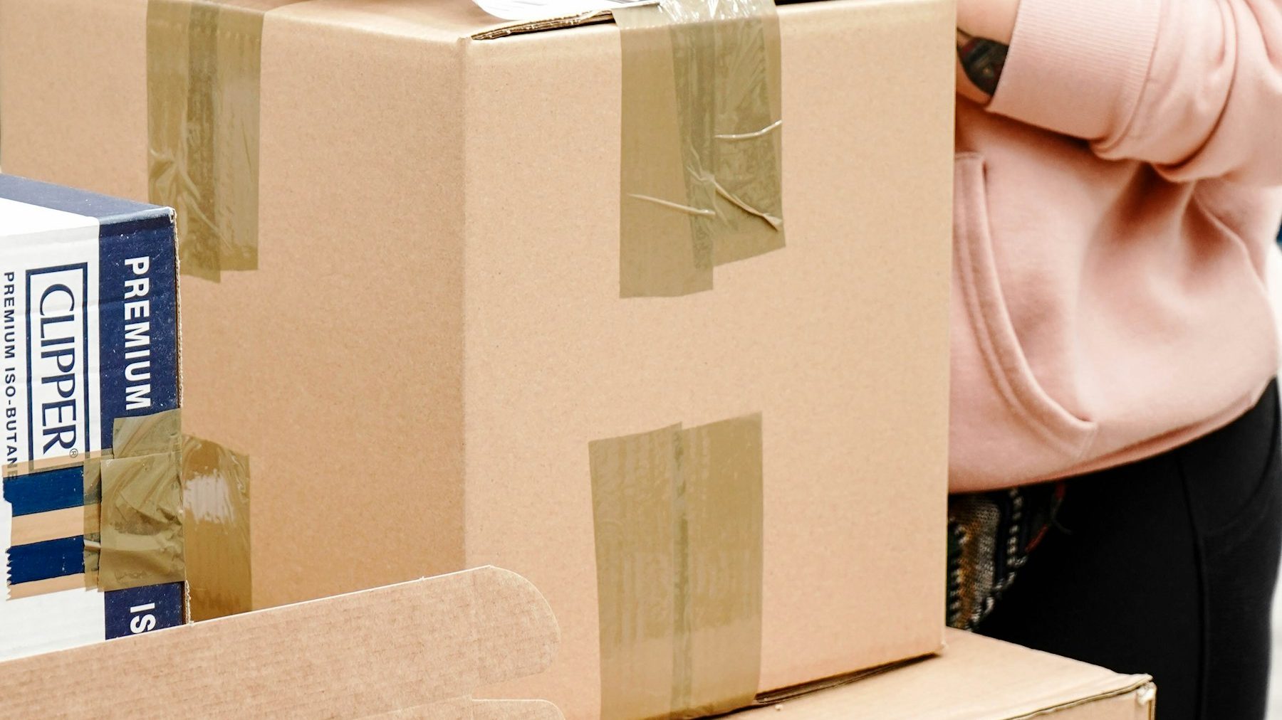 Moving to Shopify from other platforms: a woman labelling a package for posting