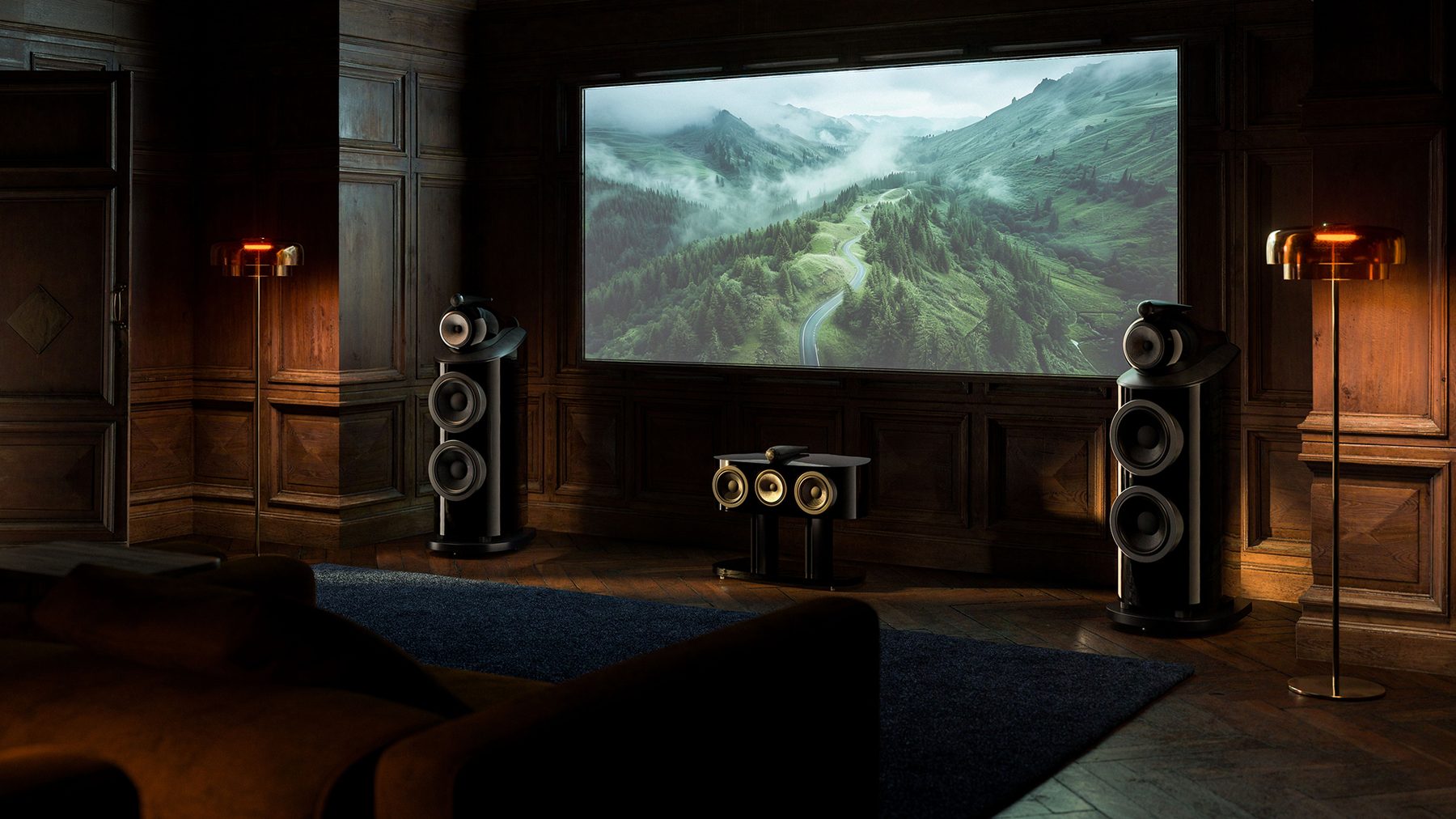 Shopify agency vs freelancer: a high-end home cinema room with floor-standing speakers either side of a large screen