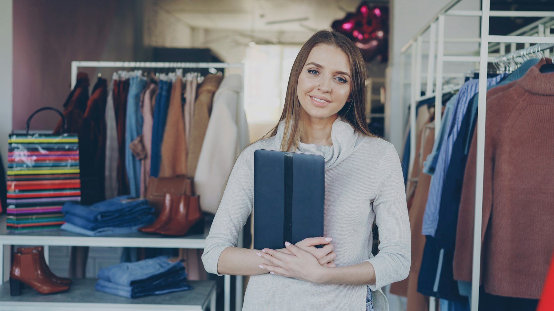 EKM, ShopWired or Sellerdeck to Shopify: a woman standing in an independent clothing shop